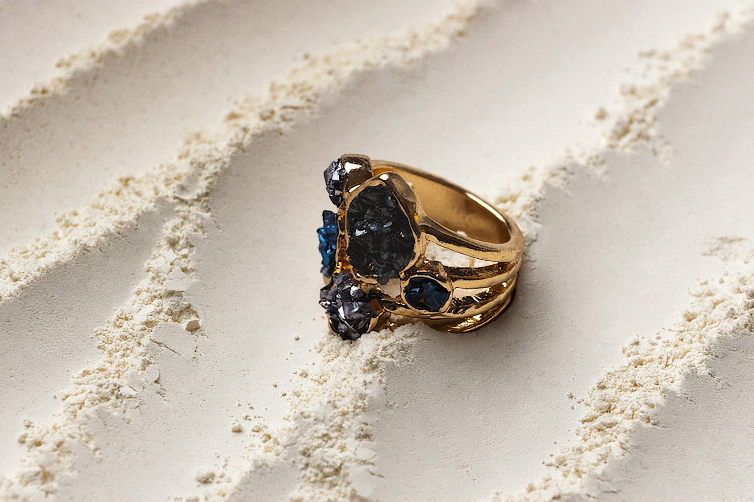 A gold ring resting in sand